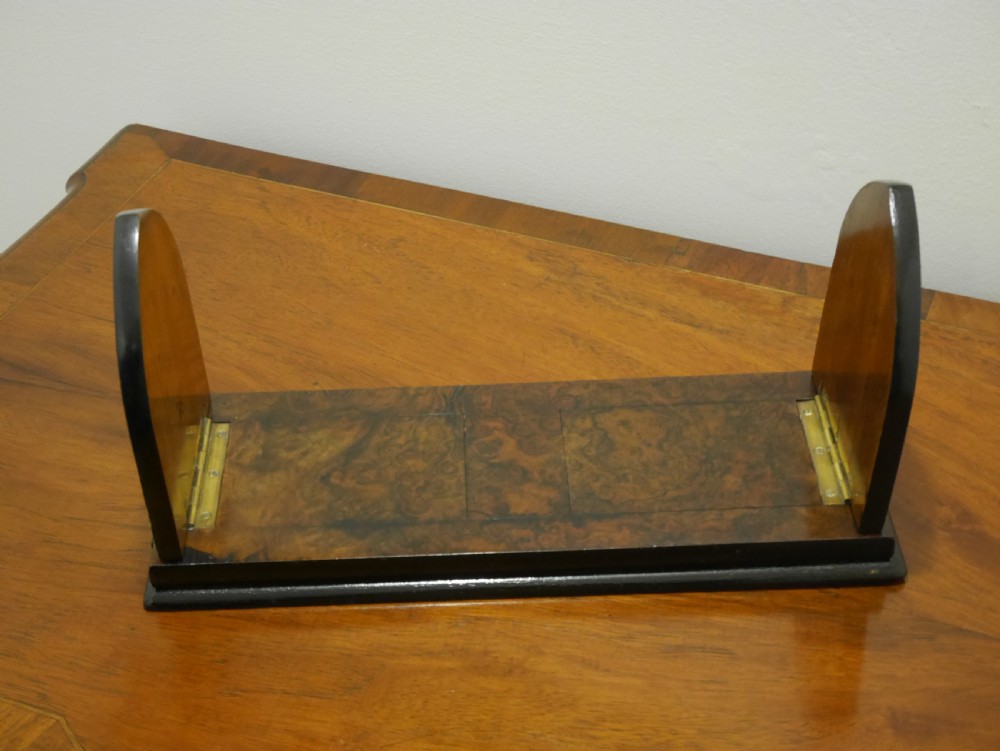 A nineteenth-century walnut book slide shown folded flat, decorated with pierced brass foliate strapwork on the hinged end panels. View II