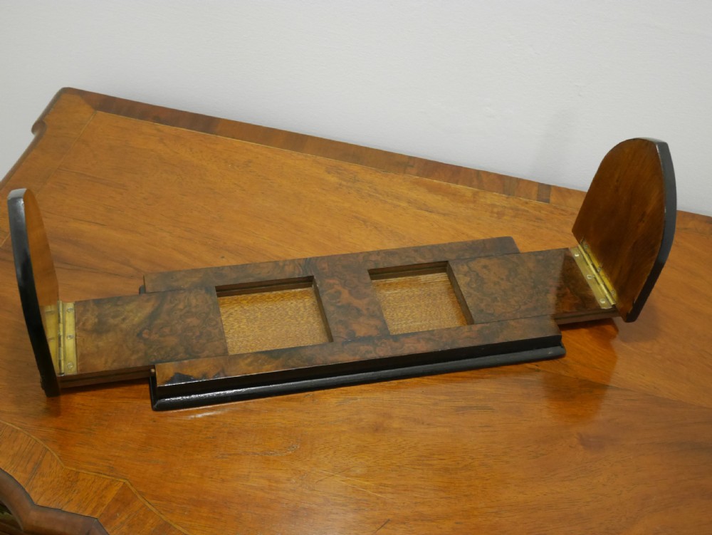 A nineteenth-century walnut book slide shown folded flat, decorated with pierced brass foliate strapwork on the hinged end panels. View III
