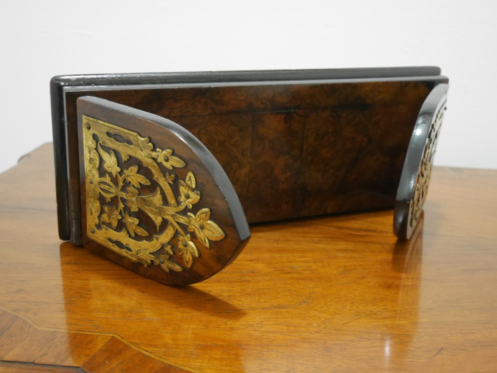 A nineteenth-century walnut book slide shown folded flat, decorated with pierced brass foliate strapwork on the hinged end panels. View V