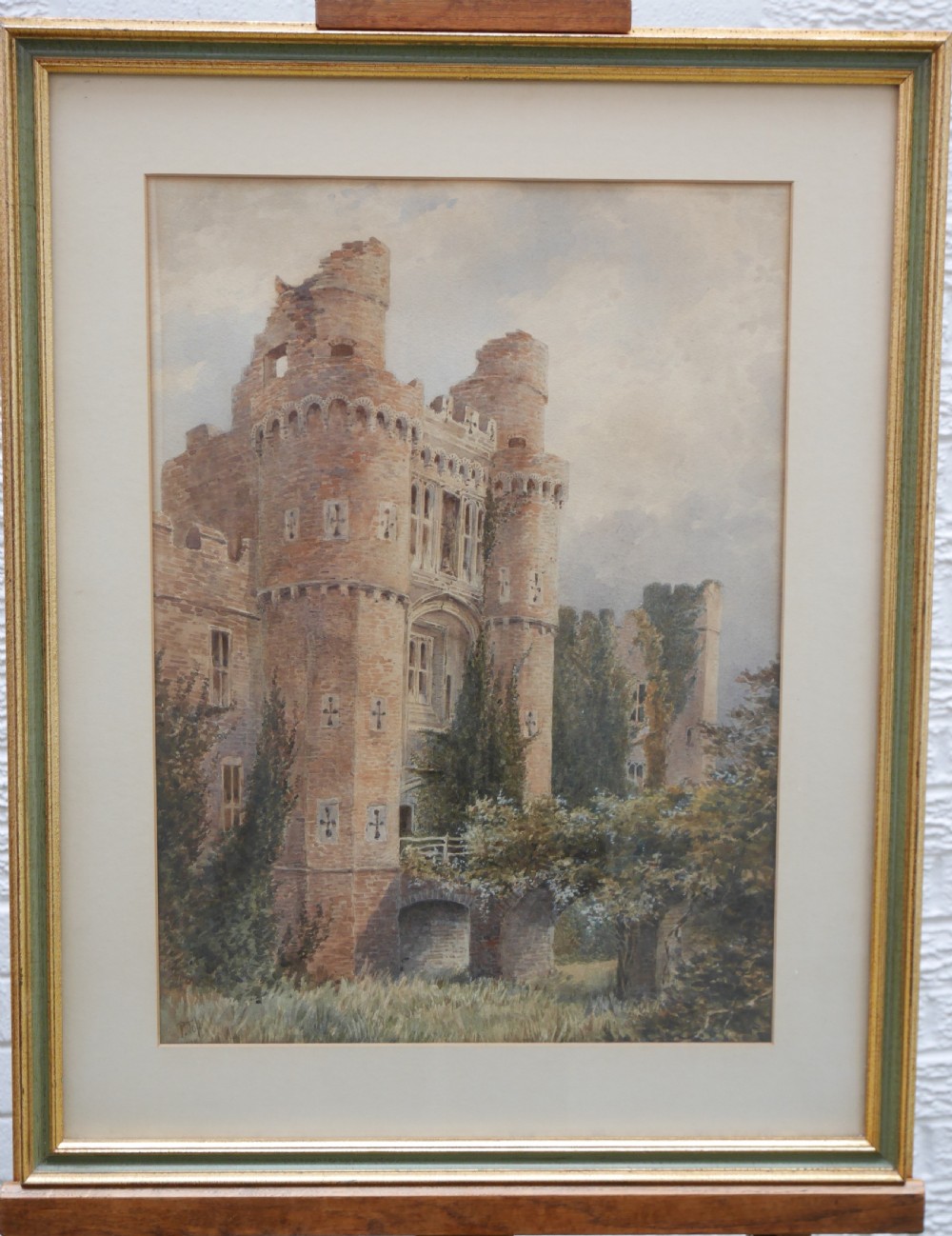 A framed nineteenth-century watercolour painting depicting a detailed ruin of a brick castle tower surrounded by greenery.