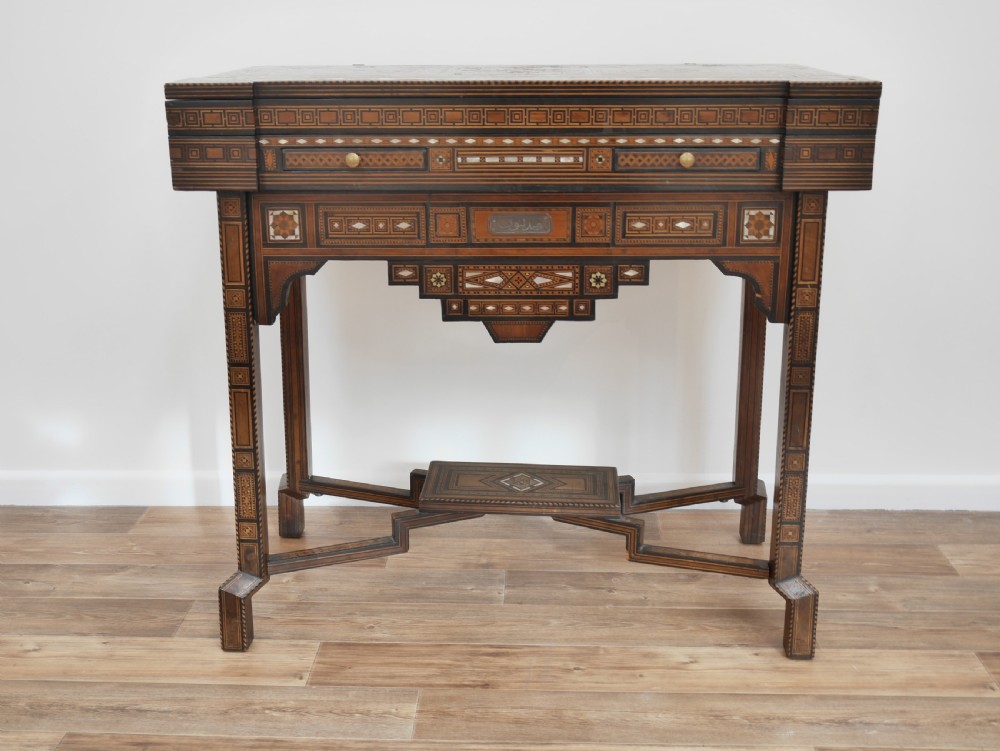 An antique rectangular Syrian games table featuring geometric micro-mosaic wood and mother-of-pearl inlays, turned drawers, and an intricate lower stretcher frame. View II
