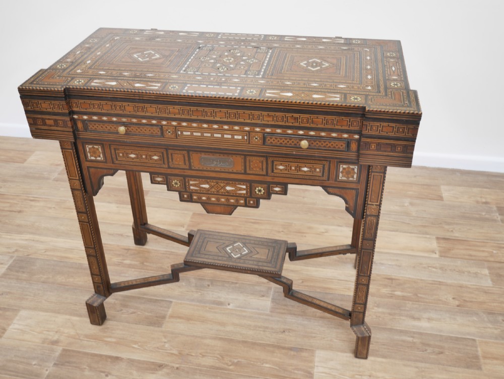 An antique rectangular Syrian games table featuring geometric micro-mosaic wood and mother-of-pearl inlays, turned drawers, and an intricate lower stretcher frame. View III