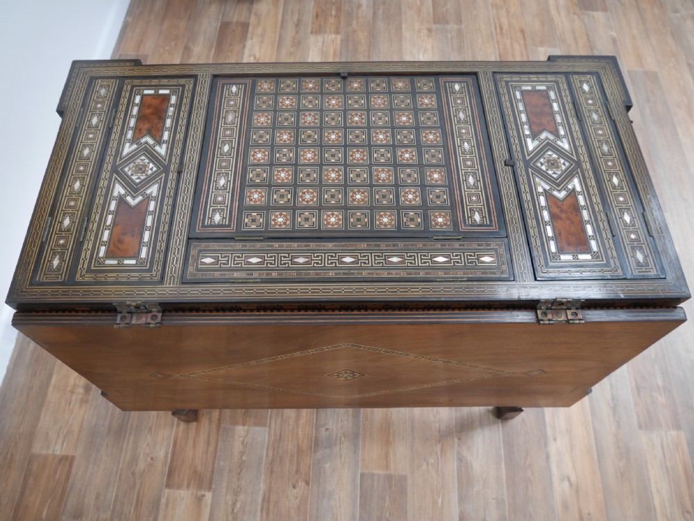 An antique rectangular Syrian games table featuring geometric micro-mosaic wood and mother-of-pearl inlays, turned drawers, and an intricate lower stretcher frame. View VI