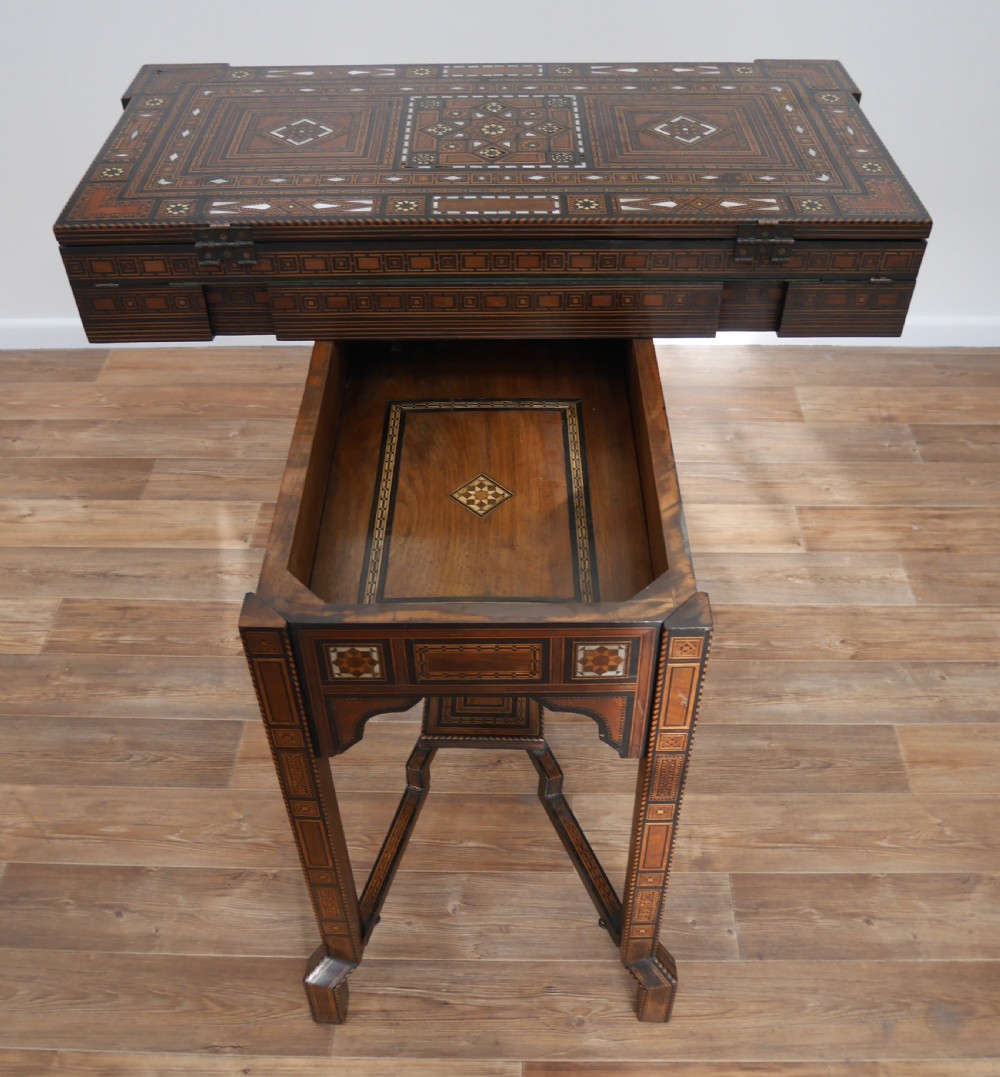 An antique rectangular Syrian games table featuring geometric micro-mosaic wood and mother-of-pearl inlays, turned drawers, and an intricate lower stretcher frame. View VIII