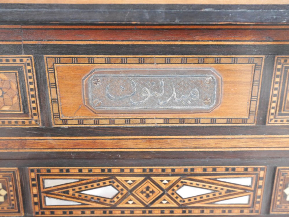 An antique rectangular Syrian games table featuring geometric micro-mosaic wood and mother-of-pearl inlays, turned drawers, and an intricate lower stretcher frame. View XII