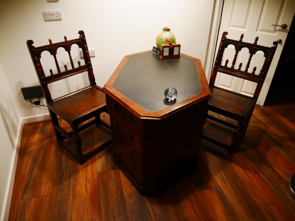Pair of 17th-century dark oak Derbyshire side chairs featuring arcaded back rails with turned finials and solid wood panel seats. View VI