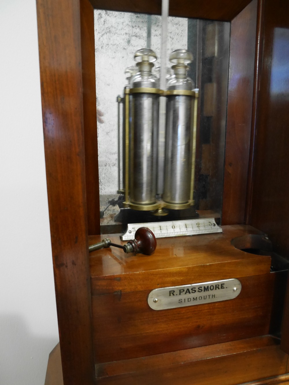 A Victorian mahogany regulator longcase clock featuring an arched hood, a circular white dial with Roman numerals, and a glazed trunk displaying the pendulum mechanism. View III