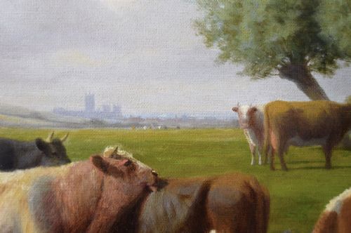 fig 3. A gilded ornate frame enclosing an oil painting of cattle standing in a stream within a green pastoral landscape.