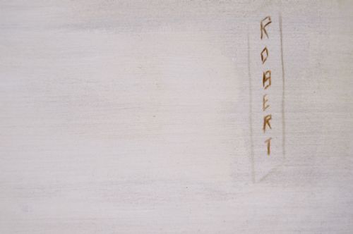 fig 4. An oil painting depicting a tan Pekingese dog named Robert resting on a dark cushion, set within a gilded frame.