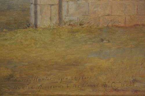 fig 4. An antique oil painting depicting a saddled chestnut hunter horse standing profile against a stone stable wall within a carved gilt wood frame.
