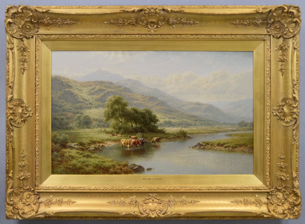 An oil painting depicting cattle watering in the River Llugwy with Welsh mountains in the background, housed in an elaborate gold gilt frame.