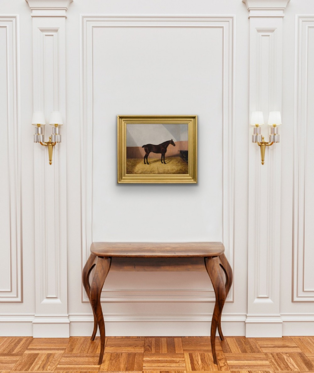 An oil painting depicting a dark bay horse standing in a straw-filled stable stall, encased within a heavy gold gilt frame. View VII
