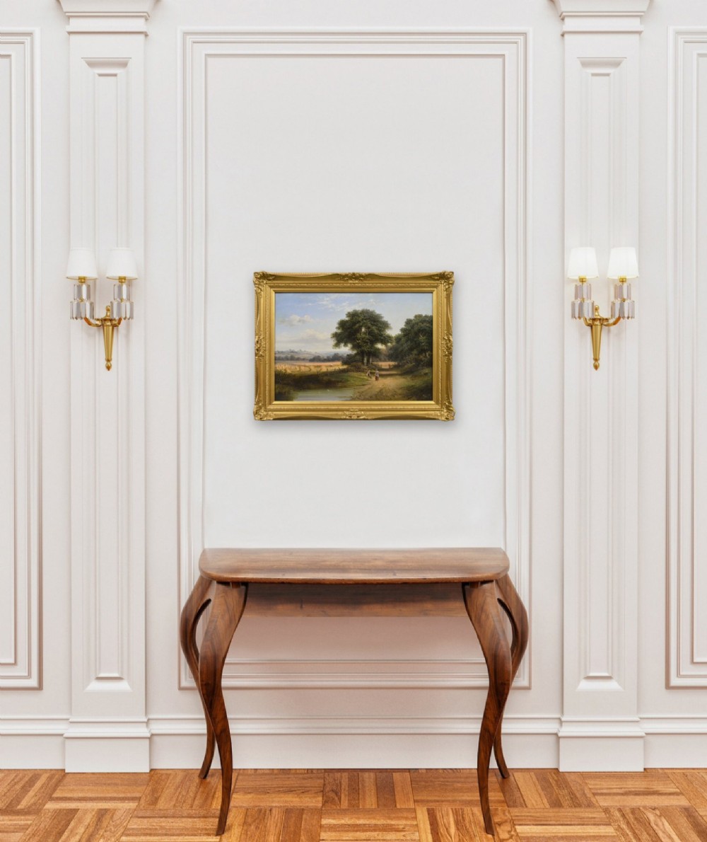A 19th-century Victorian oil painting depicting a rural harvest field with figures along a dirt track, presented in an ornate giltwood frame. View X