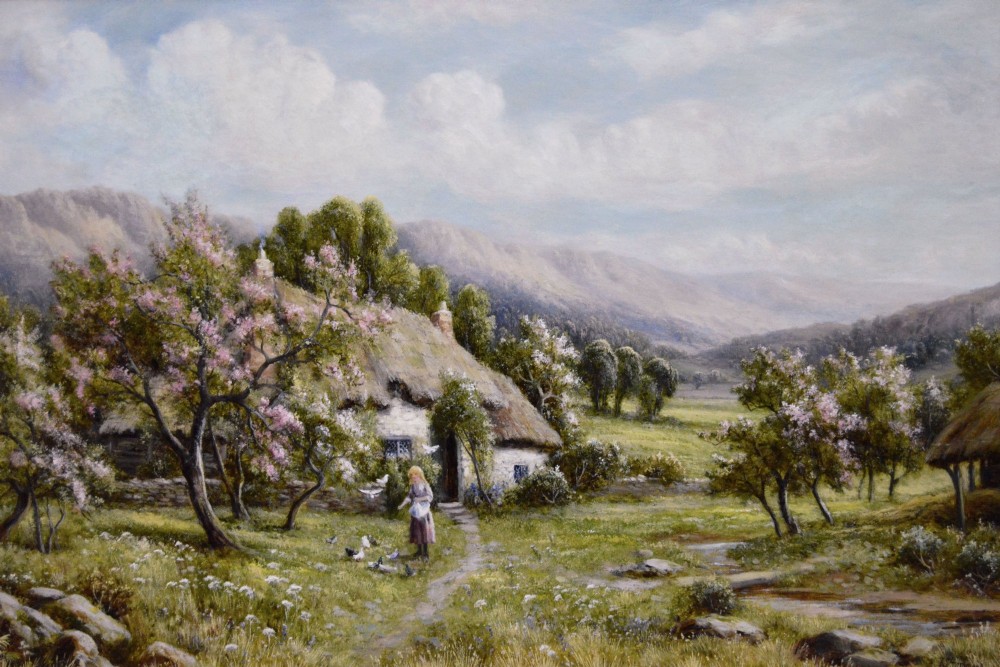 A framed oil painting depicting a thatched rural cottage surrounded by blossom trees with a figure outside and hills in the background. View II