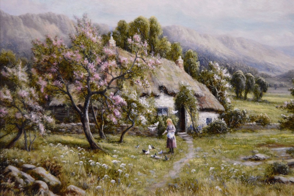 A framed oil painting depicting a thatched rural cottage surrounded by blossom trees with a figure outside and hills in the background. View III