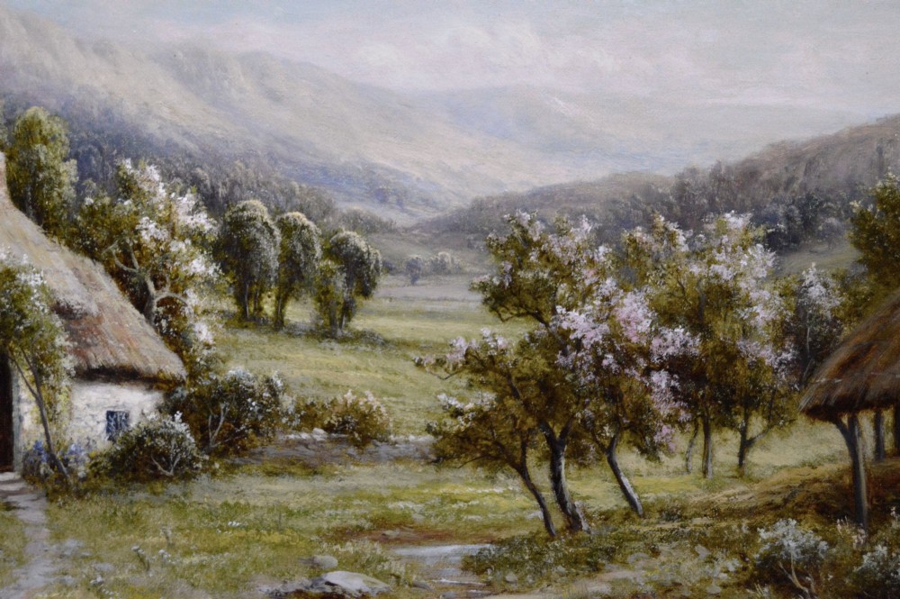 A framed oil painting depicting a thatched rural cottage surrounded by blossom trees with a figure outside and hills in the background. View IV