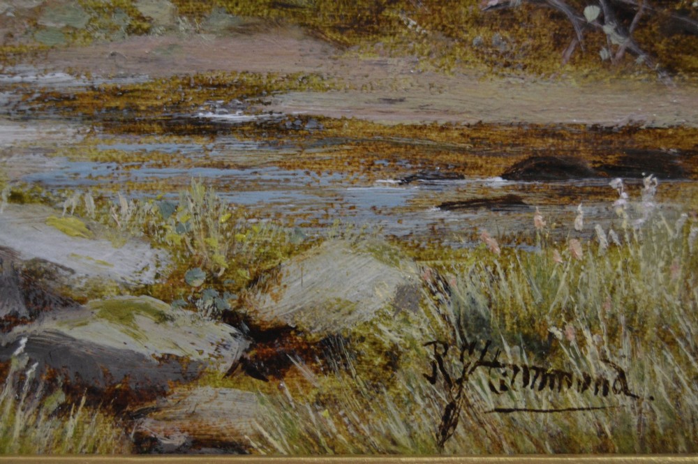 A framed oil painting depicting a thatched rural cottage surrounded by blossom trees with a figure outside and hills in the background. View V