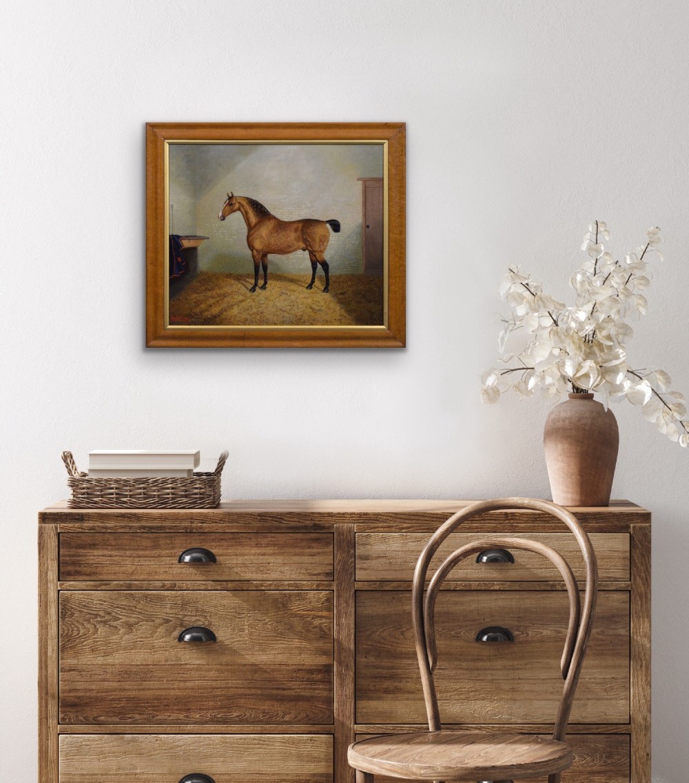 A nineteenth-century oil painting featuring a dappled buckskin horse standing in profile inside a stable, framed by a timber surround with a gilt inner slip. View IX