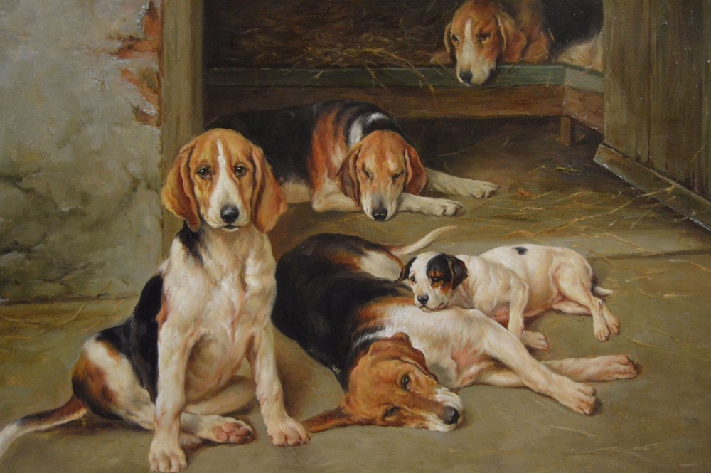 An oil painting depicting several foxhound puppies and a fox terrier resting on a barn floor, set within a heavy carved gilded frame. View III