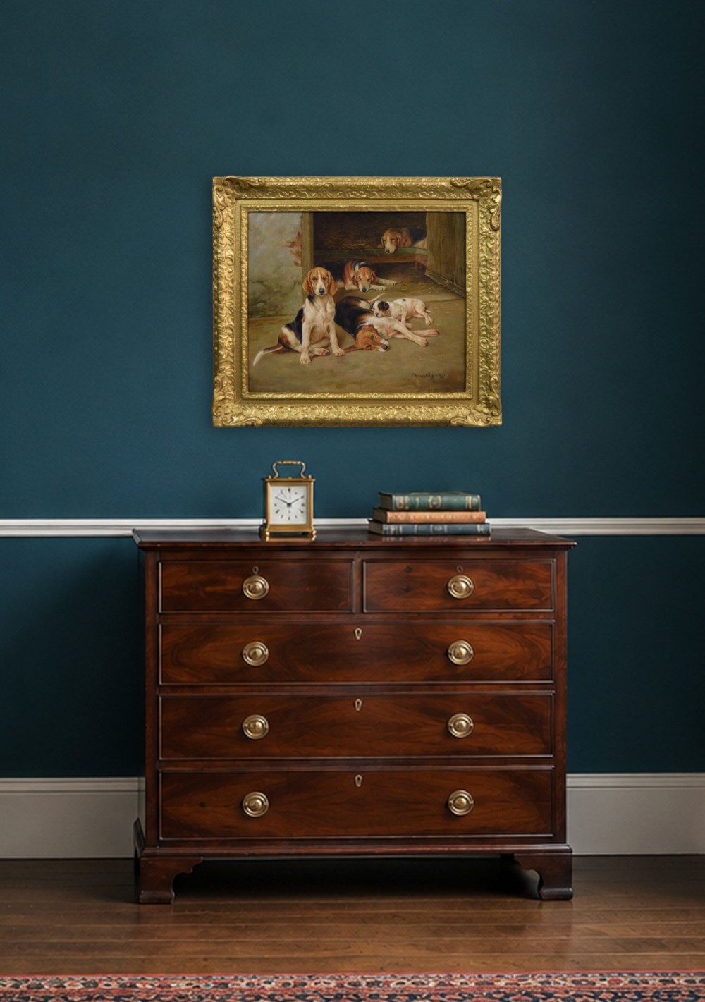 An oil painting depicting several foxhound puppies and a fox terrier resting on a barn floor, set within a heavy carved gilded frame. View XII