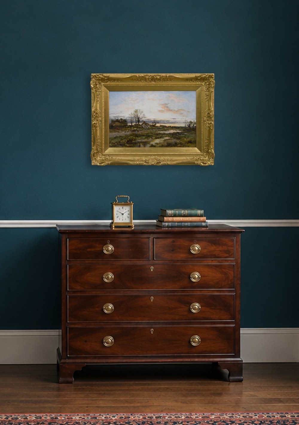 A framed Victorian oil painting depicting a rural English common at dusk with cottages, figures, and water pools set inside an elaborate gold gilt frame. View XII