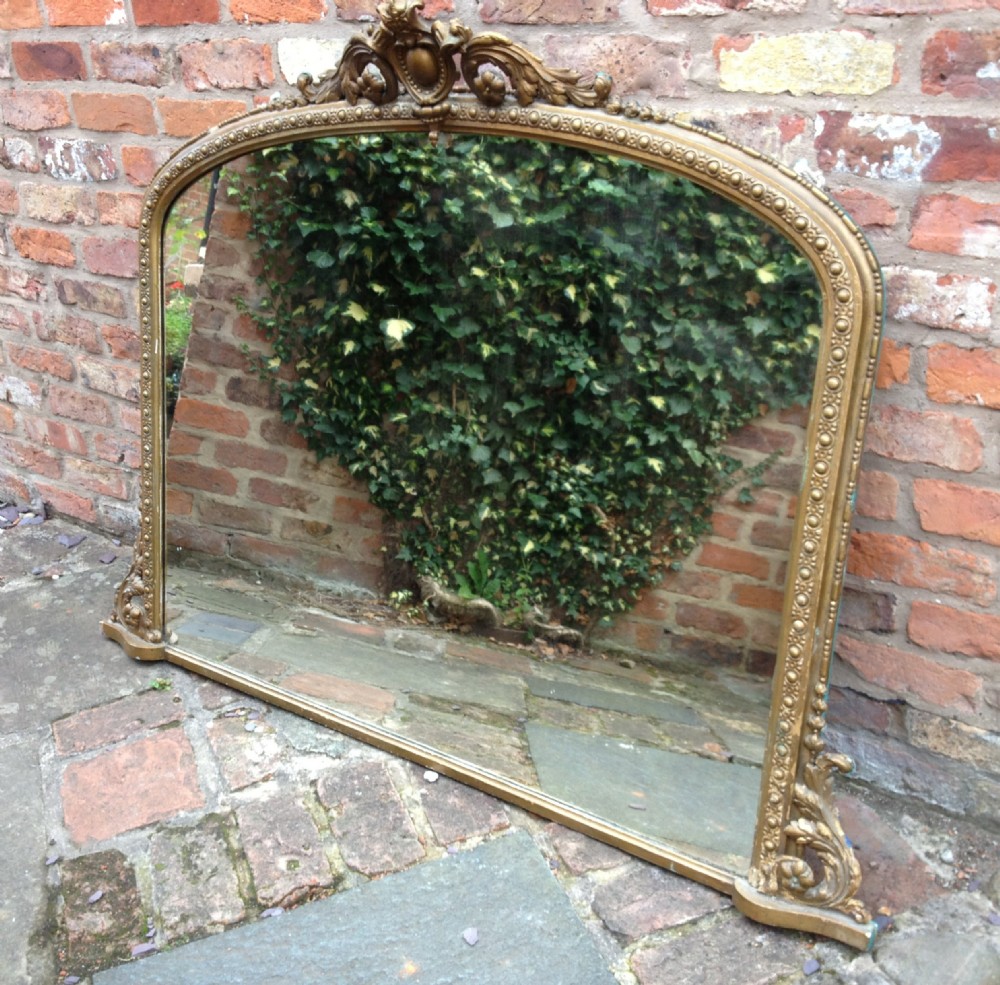 Victorian gilt over mantel mirror with well decorated frame circa 1870
