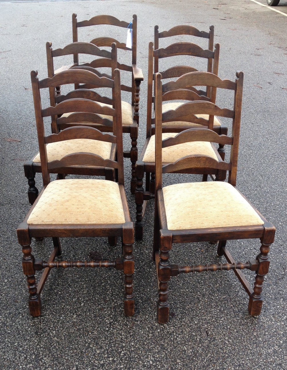 Set of six solid oak dining chairs on bobbin turned supports with ladder backs circa 1920