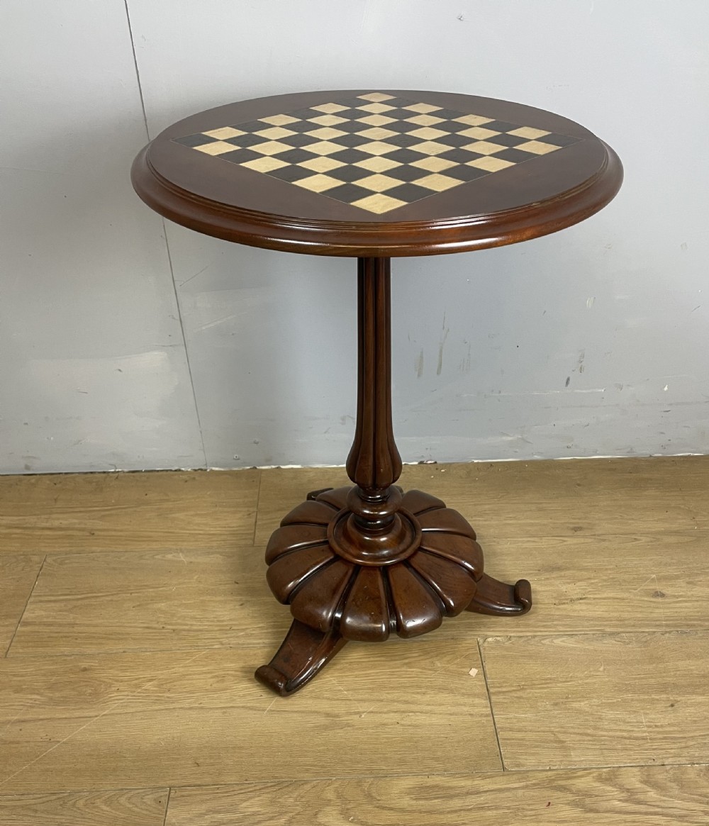 C19TH walnut games table on a carved base 