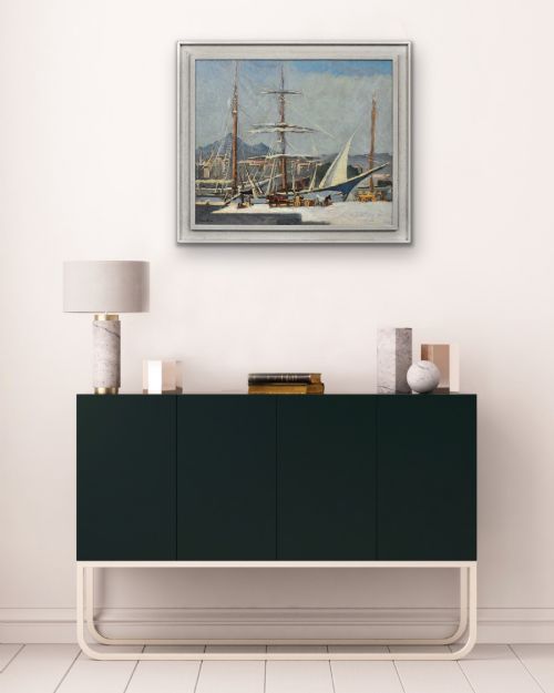 fig 10. A framed 1930s oil painting depicting masted ships and horse-drawn carts along a harbour dock under a grey sky.