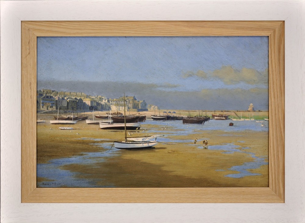 A framed horizontal oil painting depicting wooden fishing boats resting on sandy shores at low tide in St Ives harbour.