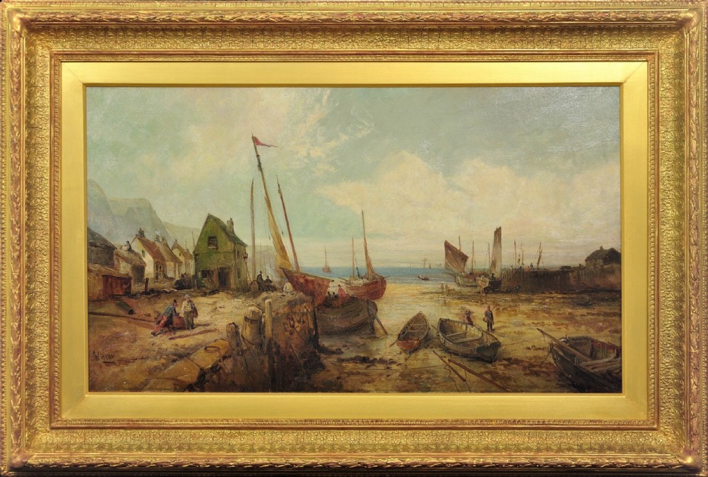 A nineteenth-century framed oil painting depicting fishing boats docked at a harbour shore beside coastal buildings, encased in a decorative gold leaf frame.