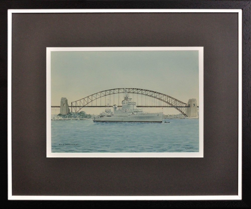 Framed maritime watercolour painting depicting HMS Newcastle passing in front of the Sydney Harbour Bridge against a light blue sky and harbour water.