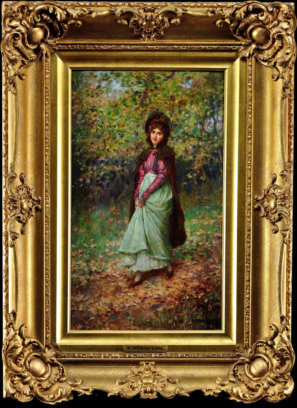 An antique Victorian oil painting depicting a woman in a forest setting, displayed inside a heavy gilded carved frame.