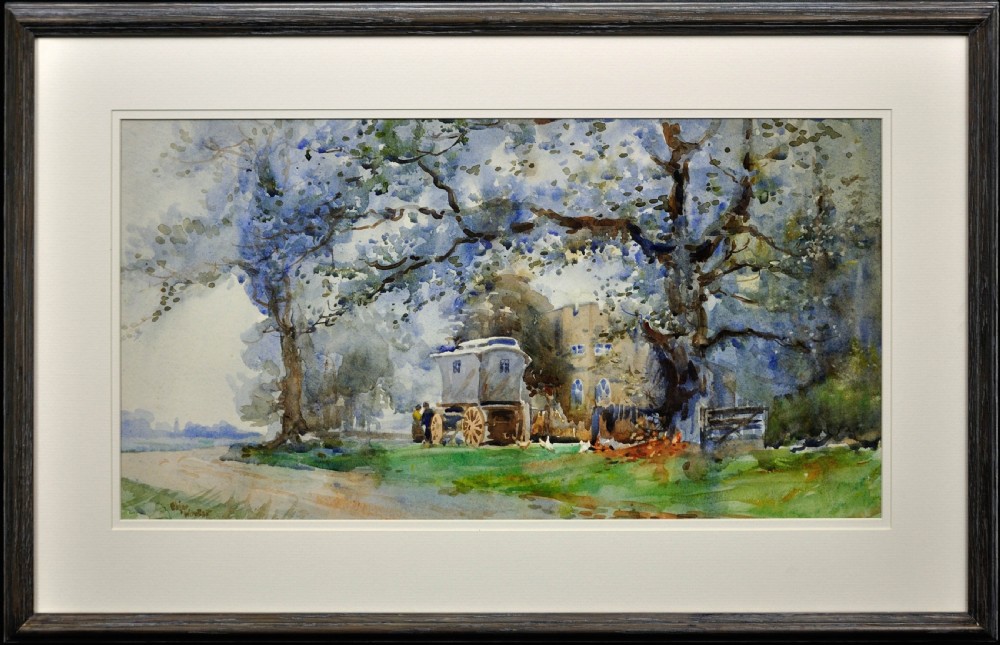 A framed watercolour painting depicting a traditional Romany gypsy caravan parked under large trees beside a stone building.