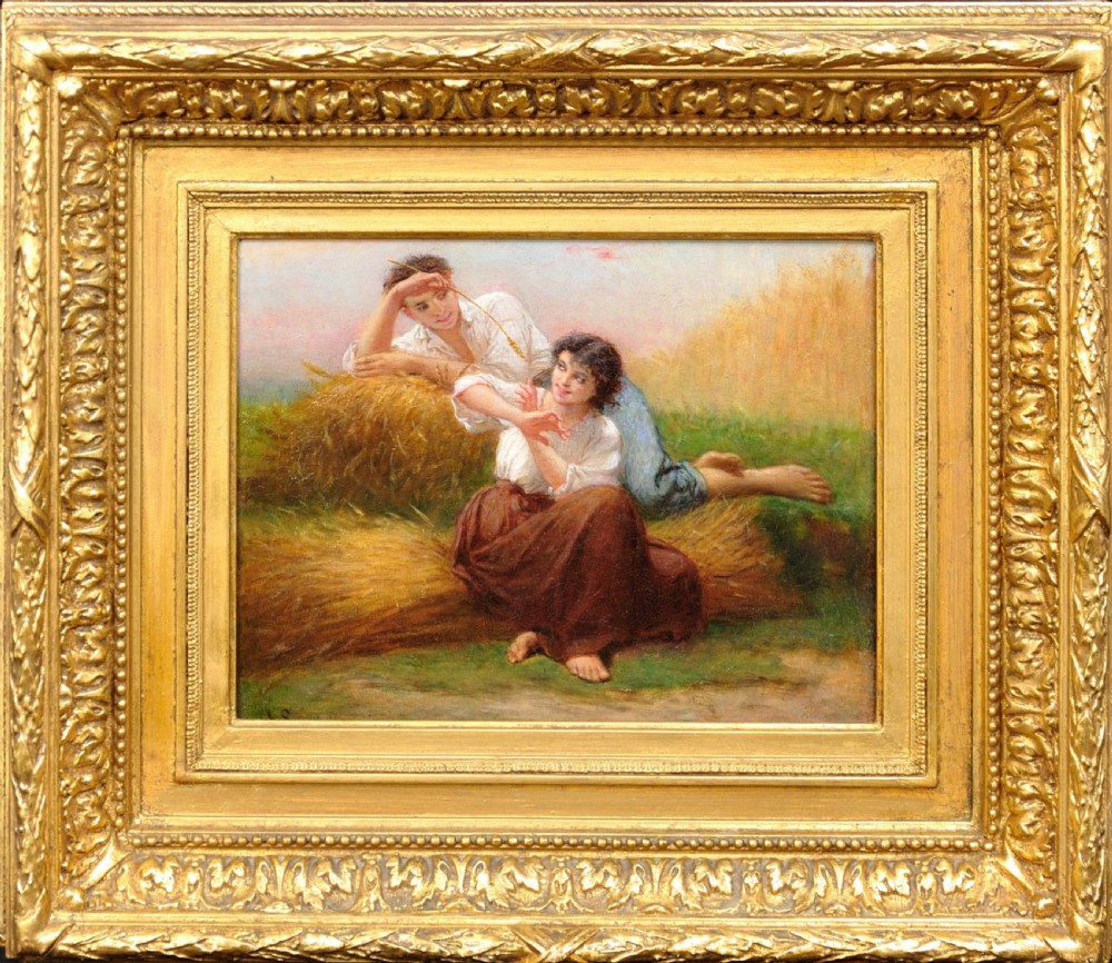 A framed 19th-century French oil painting depicting a couple seated in a harvest field, set within a wide gilded frame featuring leaf motifs.