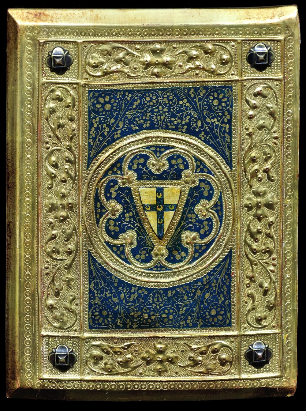 A framed rectangular gilded wooden book cover panel featuring punchwork, foliate borders, four metal corner studs, and a central coat of arms set against a blue painted background. View II