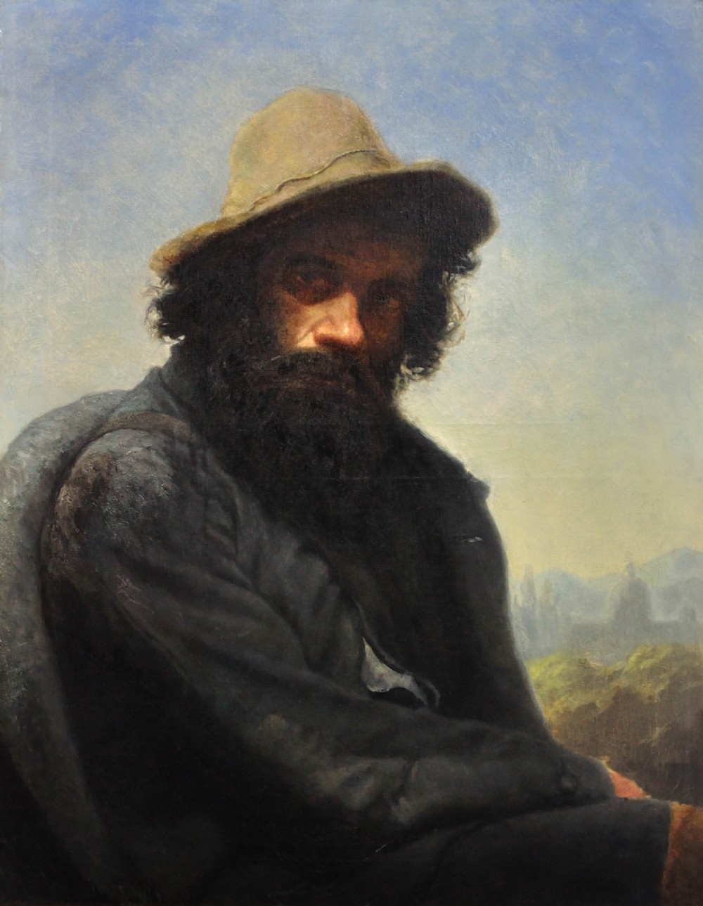 A 19th-century framed oil portrait depicting a bearded man wearing a hat and dark coat against a soft landscape background, housed in an ebonised frame with a gilt slip. View II