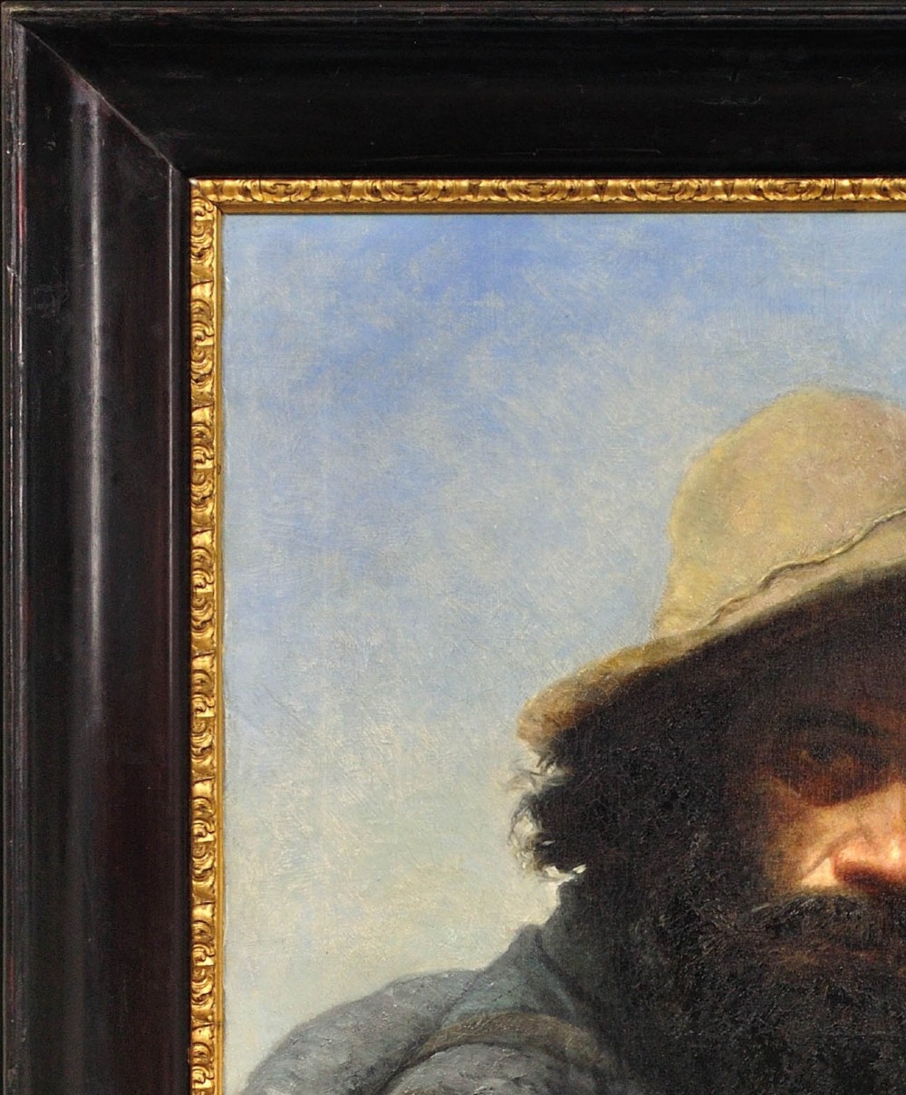 A 19th-century framed oil portrait depicting a bearded man wearing a hat and dark coat against a soft landscape background, housed in an ebonised frame with a gilt slip. View V