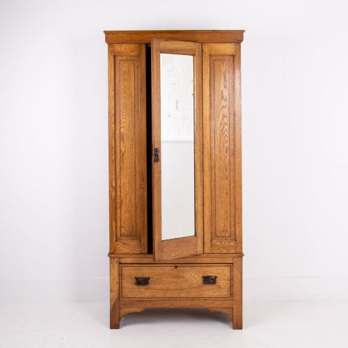 fig 1. An Edwardian single-door oak wardrobe featuring a central vertical mirror, recessed side panels, a single base drawer, and a stepped top cornice.