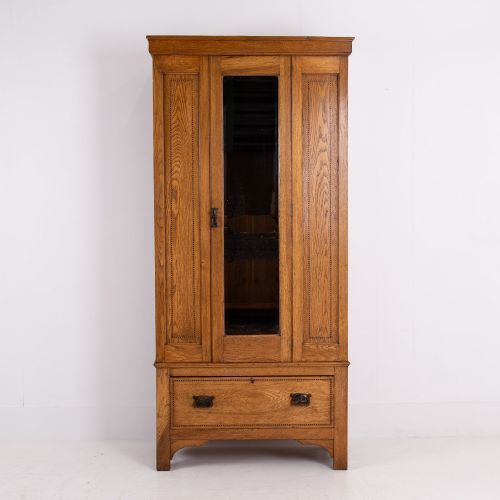 fig 2. An Edwardian single-door oak wardrobe featuring a central vertical mirror, recessed side panels, a single base drawer, and a stepped top cornice.
