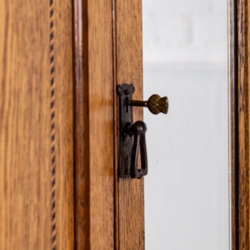 fig 3. An Edwardian single-door oak wardrobe featuring a central vertical mirror, recessed side panels, a single base drawer, and a stepped top cornice.