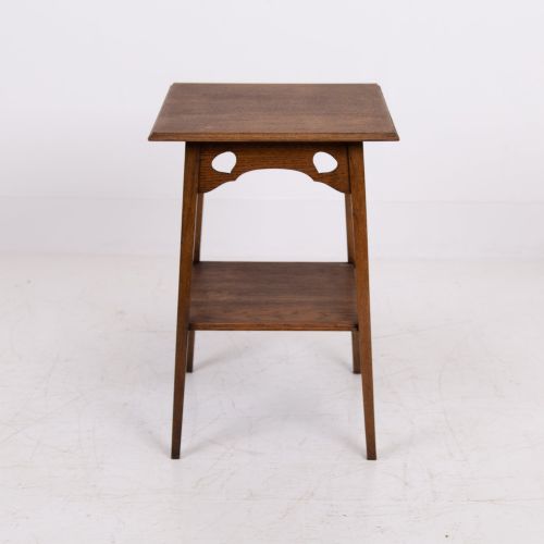 fig 1. An Arts and Crafts solid oak two-tier side table with tapered legs and heart-shaped pierced motifs along the apron.