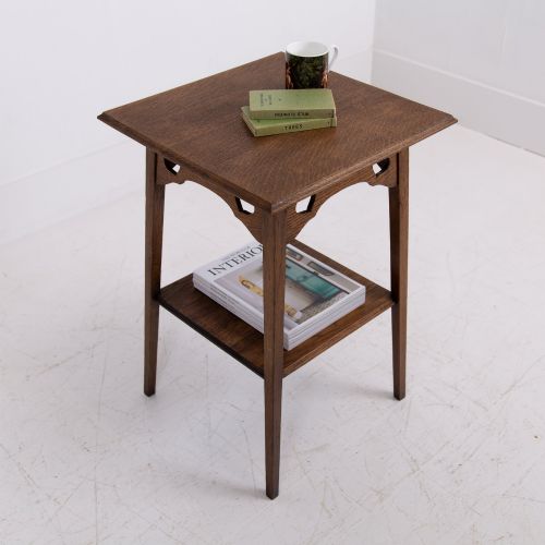 fig 2. An Arts and Crafts solid oak two-tier side table with tapered legs and heart-shaped pierced motifs along the apron.