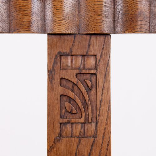 fig 3. A set of four 1930s oak dining chairs featuring carved back splats, fluted top rails, and green velvet upholstered seats.