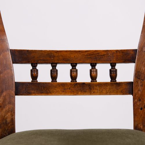 fig 2. A set of six late Victorian wooden dining chairs featuring curved open backrests with spindle galleries, turned front legs, and olive green velvet seats.
