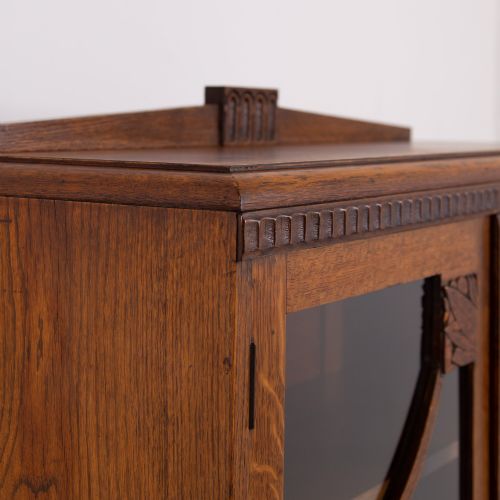 fig 2. An Art Deco medium oak glazed bookcase featuring twin doors with decorative geometric wooden glazing bars and squat turned feet.
