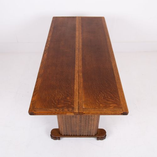 fig 3. An Art Deco medium oak dining set comprising a rectangular pedestal table and four matching chairs with brown leather seats.