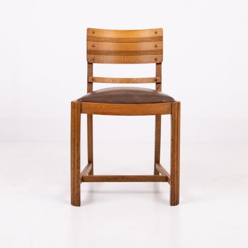 fig 4. An Art Deco medium oak dining set comprising a rectangular pedestal table and four matching chairs with brown leather seats.