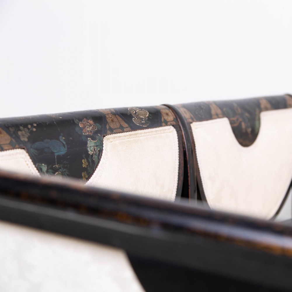 A Victorian Chinoiserie sofa with a black lacquered frame featuring gilt painted details, semicircular cream patterned back panels, and cream upholstered seat cushions. View IV