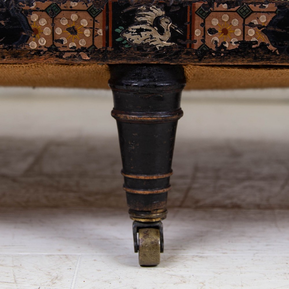 A Victorian Chinoiserie sofa with a black lacquered frame featuring gilt painted details, semicircular cream patterned back panels, and cream upholstered seat cushions. View XII